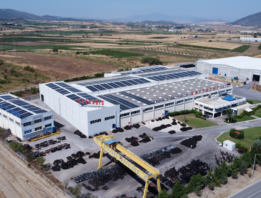 Aerial view of Katradis S.A. rope manufacturing and storage facility with solar panels and outdoor anchor yard in Greece.