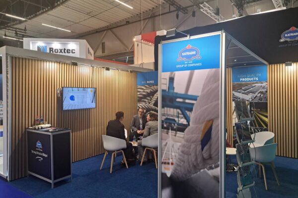 Katradis exhibition booth at Europort 2025 with visitors meeting and discussing maritime solutions.