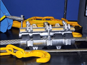 Pneumatic wire rope lubricator installed around a steel wire rope during the lubrication process.